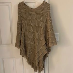 Tan poncho with fringe detail!